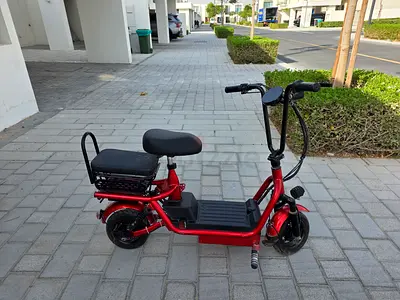 Red electric scooter with rear seat - used, good condition. Battery replacement required