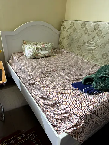 White single bed frame without mattress