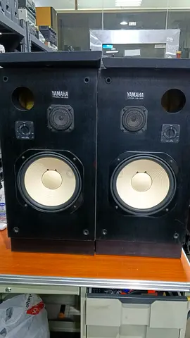 vintage Yamaha NS-355 speakers featuring a distinctive white woofer cone and a black cabinet