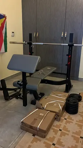 Barely Used Home Gym Benchpress - Comes With Olympic Rolling Barbell and Large Set Of Weights