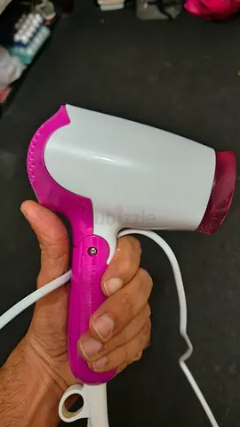 Compact travel hair dryer — foldable, pink/white, works fine