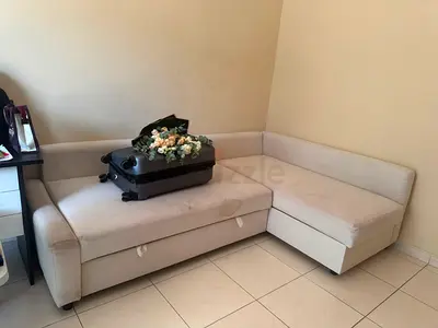 L-shaped beige corner sofa with storage, good condition