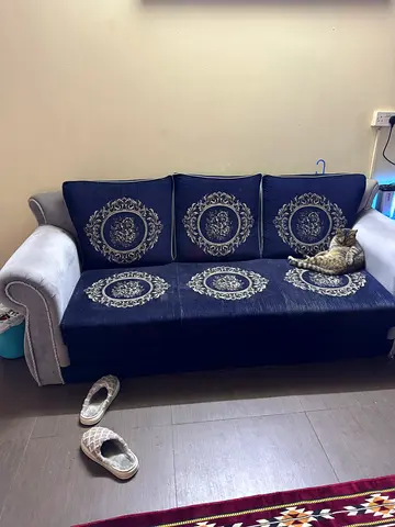 3-seater navy blue fabric sofa with patterned cushions - good condition
