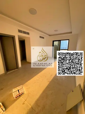 Two-bedroom apartment with a living room in Al Jurf 3—first-time occupancy. Features two master bedrooms, three bathrooms, a balcony, and a laundry ro