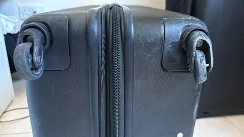 Delsey Black hardshell carry-on suitcase with replacement wheels needed