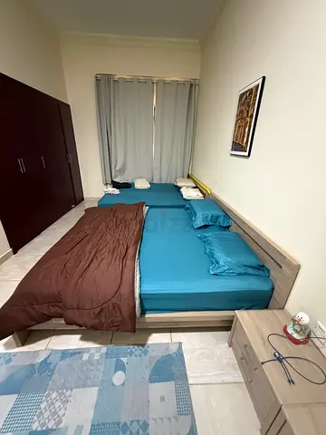 Pair of single beds with mattresses and bedside table - used