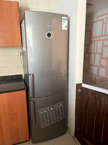 Silver double-door refrigerator in good condition