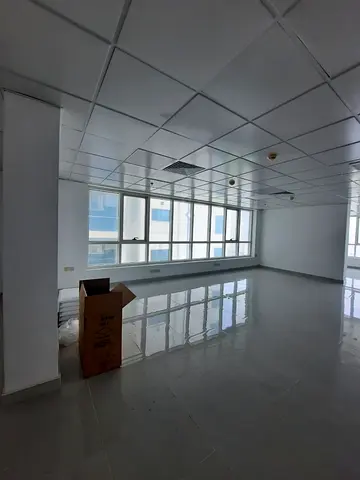 Semi-partitioned office with direct Al Majaz Park view | Free A/C & 2 free parking spaces | Prime location, ideal for business, close to all services.