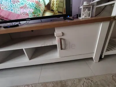 White wooden TV cabinet with storage shelf and door
