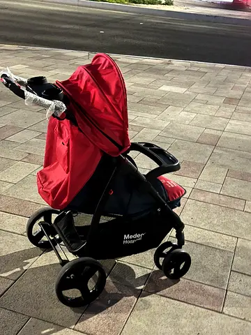 Lightweight red baby stroller in good condition