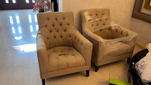 Pair of beige tufted armchairs — good condition