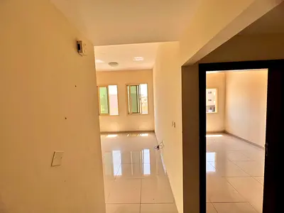 A bright apartment with a separate living room, located behind Al Hamidiya Police Station in Al Raw