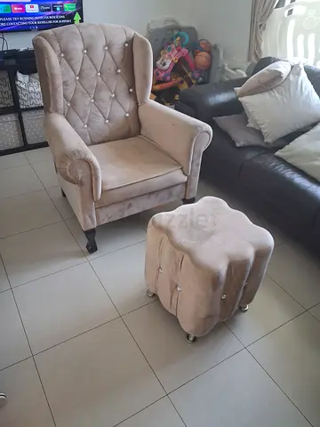 Beige tufted armchair with matching ottoman - good condition