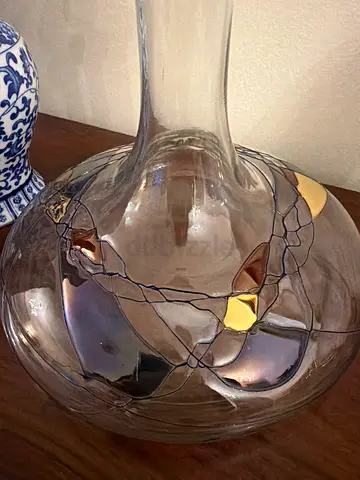 Hand-blown decorative glass vase with gold accents