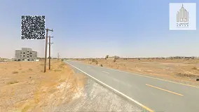 Residential land in Manama 8, behind the school