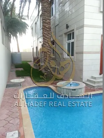 Luxury Independent Villa for Rent in Al Azra Sharjah 6 Bedrooms Two Floors Spacious Layout Separate Majlis Two Living Halls Maid Room Private Swimming