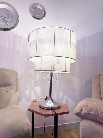 Modern chrome table lamp with layered fabric shade and crystal drops