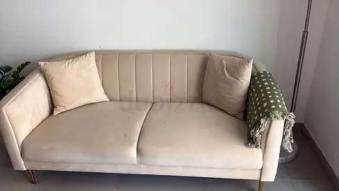 Light beige 2-seater velvet sofa with cushions — good condition