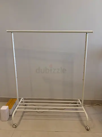 White metal clothes rack on wheels - sturdy garment rail