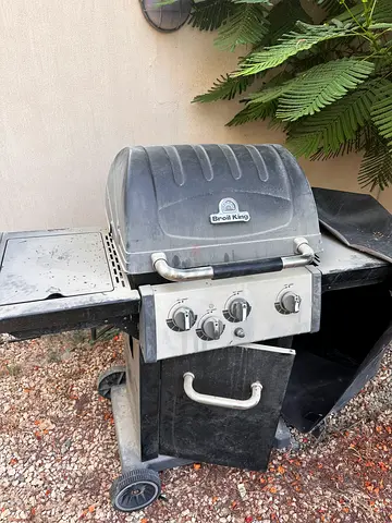 Used outdoor gas BBQ grill with side shelf and cover