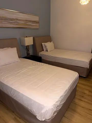 Two single beds with headboards and mattresses - good condition
