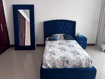 Single blue upholstered bed frame with headboard and matching bedside