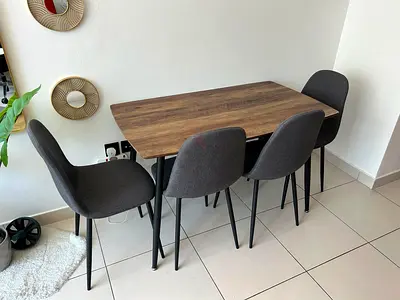 Compact wooden dining table with 4 grey upholstered chairs