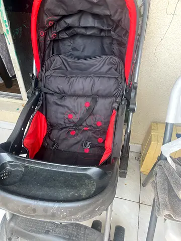 Used red and grey baby stroller/pram - good working condition