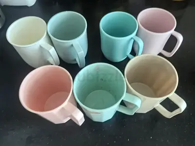 7 pastel plastic mugs — used, good condition