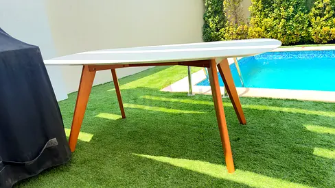 Wooden-legged dining table with white top — very good condition