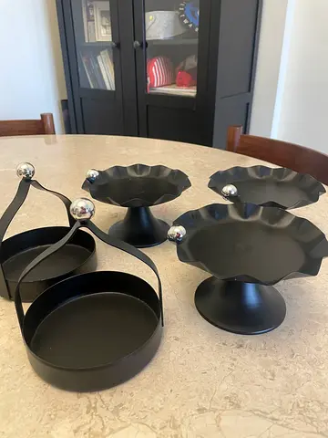 Set of black metal decorative trays and tiered stands