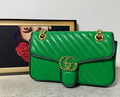 Gucci STYLE small GG Marmont shoulder bag in emerald green chevron matelassé leather.