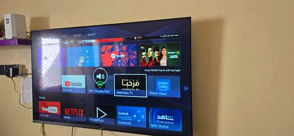 49–55 inch Smart LED TV mounted with remote (works fine)