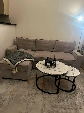 Light grey 3-seater sofa with chaise - good condition. With table and carpet for free.