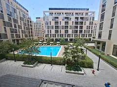 1bhk with kitchen appliances and pool view in gated community