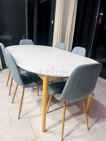 Original: AED 2,600, JYSK White Oval Dining Table with 6 Light Grey Fabric Chairs