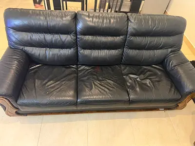 Pair of dark black leather armchairs with wooden accents