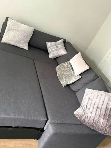 Grey L-shaped Sofa Bed with Cushions - Good Condition