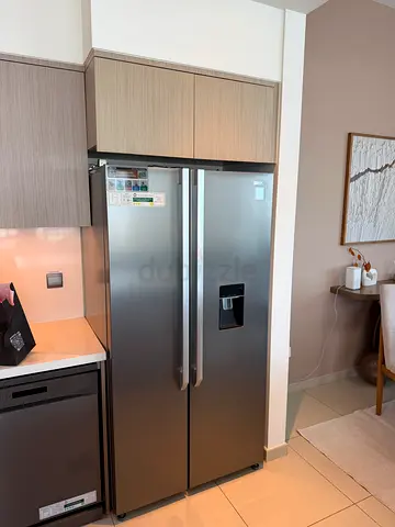 Stainless Steel Side-by-Side Refrigerator with Water Dispenser - Good Condition