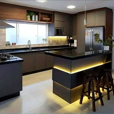 Modern dark grey kitchen island with built-in cabinets and breakfast bar