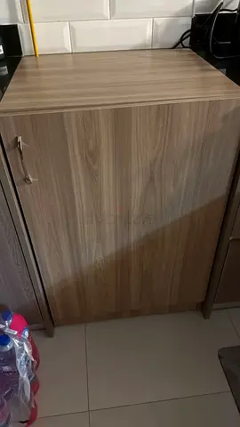 Compact wooden cabinet with single door - good condition