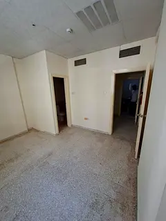 Spacious studio for rent in Al Shuwaiheen, Sharjah. Separate kitchen, central AC, natural gas, AED 1