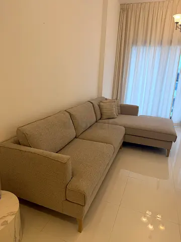 Grey L-shaped sectional sofa with cushions
