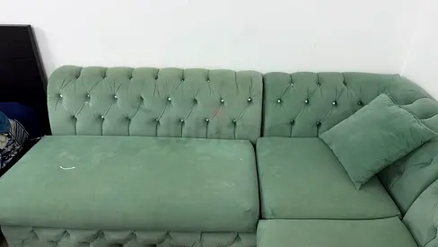 Light green tufted L-shaped sectional sofa — good condition