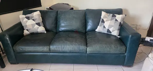 Dark green 3-seater leather sofa cum bed in excellent condition