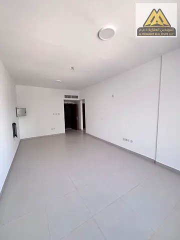 located on the second row from Ajman Corniche. The apartment features a spacious layout, an open-view balcony, and a beautiful city view in