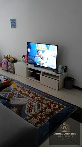 Monthly furnished 1BR near Grand Mall, spacious, balcony view, central AC, equipped kitchen, free parking, rent 3700 AED incl. bills.
