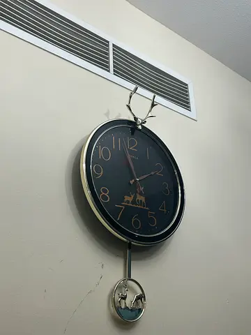 Modern Wall Clock with Pendulum and Deer Detail