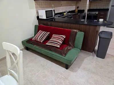 Compact green 2-seater sofa / futon - good condition