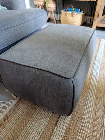 Grey fabric chair with footstool in good condition